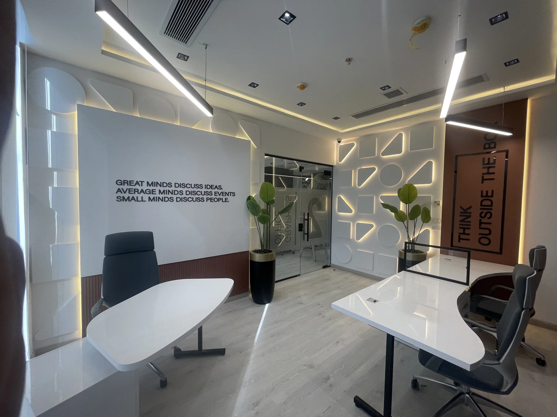 A finished workplace vignette with measured storage and warm materiality.