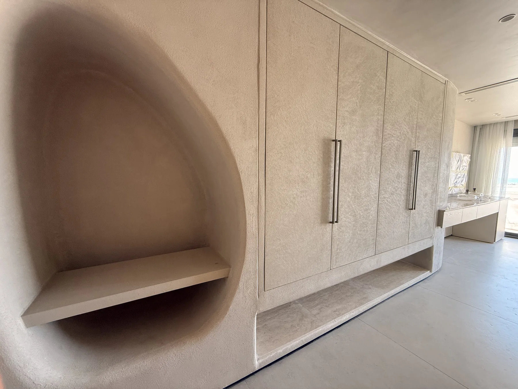 Warm joinery and measured storage carry one continuous language through the space.