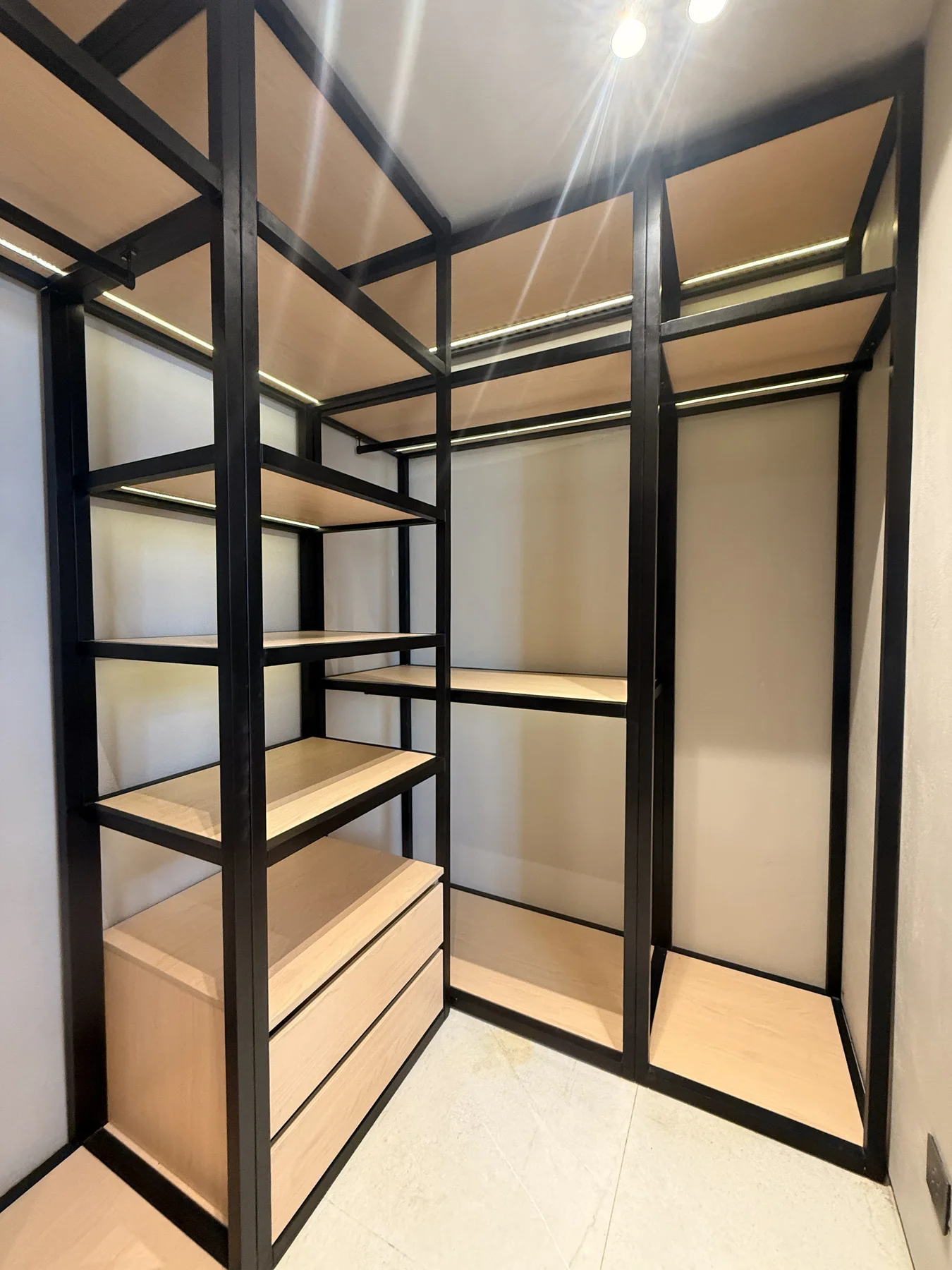 Warm joinery and measured storage carry one continuous language through the space.