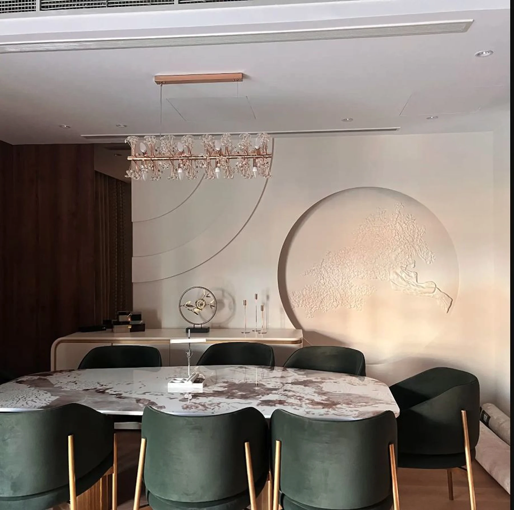 A composed dining room bringing timber, lighting and furniture into one rhythm.