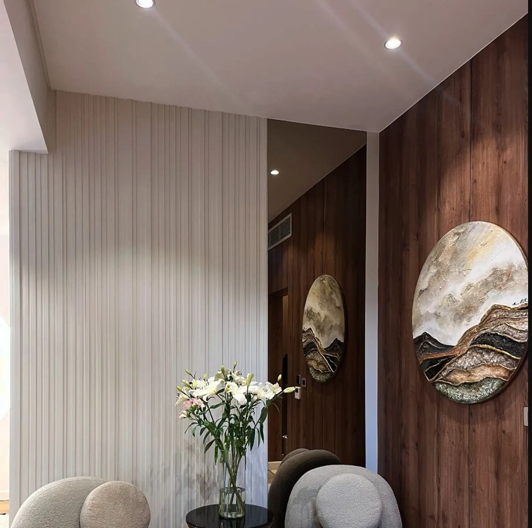 Vertical wall profiles and stone artwork shape the reception interior.