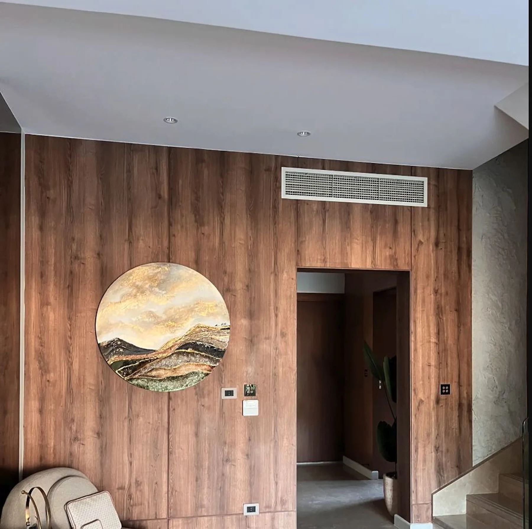 Entry wall cladding turns circulation into a considered interior moment.