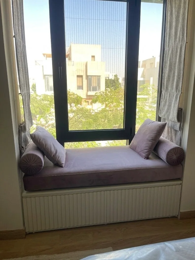 Storage, wall treatment and furniture held in one interior language.