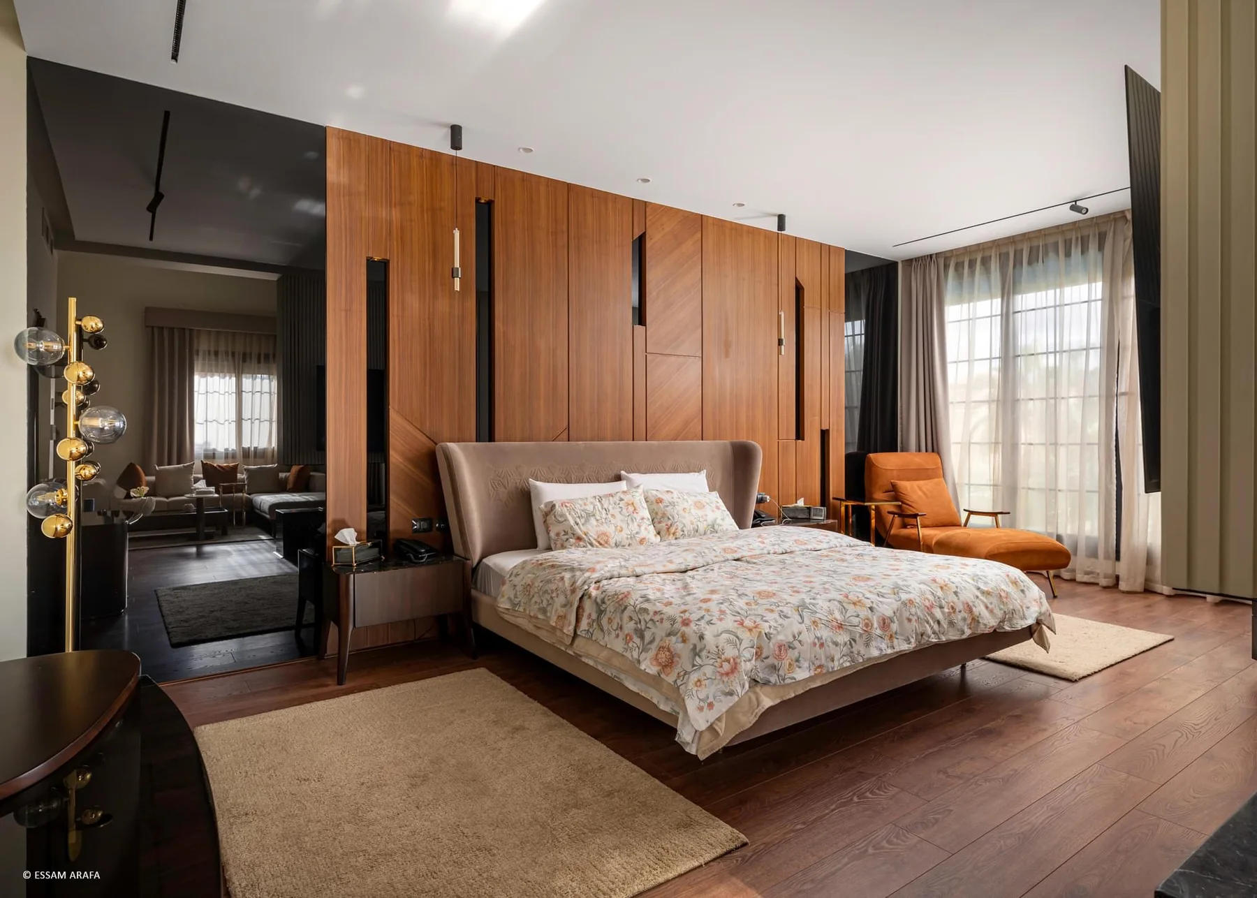 Bedroom with a full-height timber headboard wall