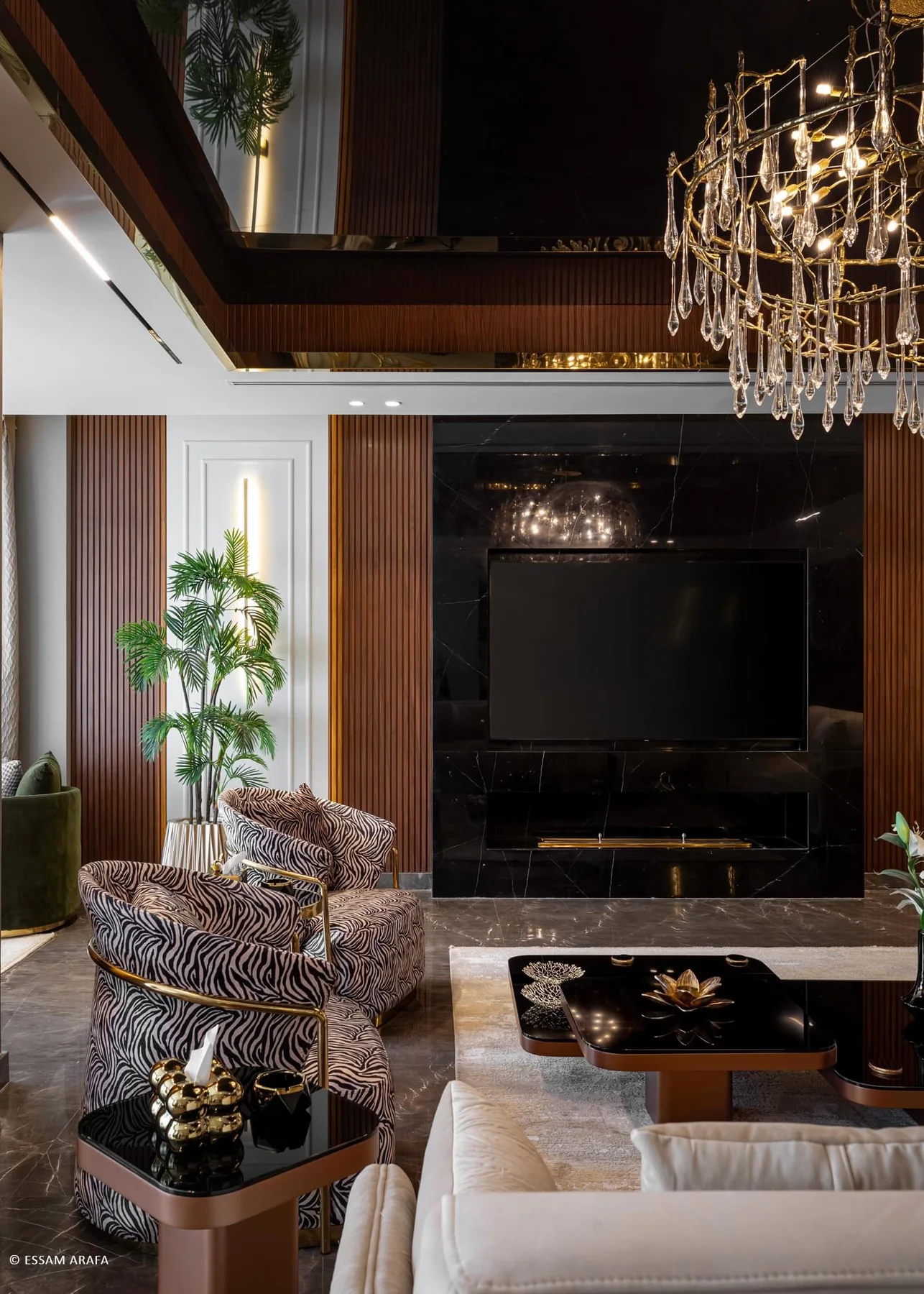 Living room with a dark media wall, timber slats and layered lighting
