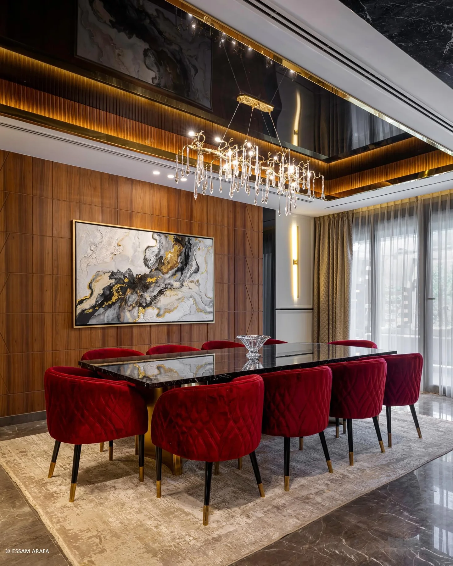 Dining room with walnut wall panels, artwork and a crystal pendant