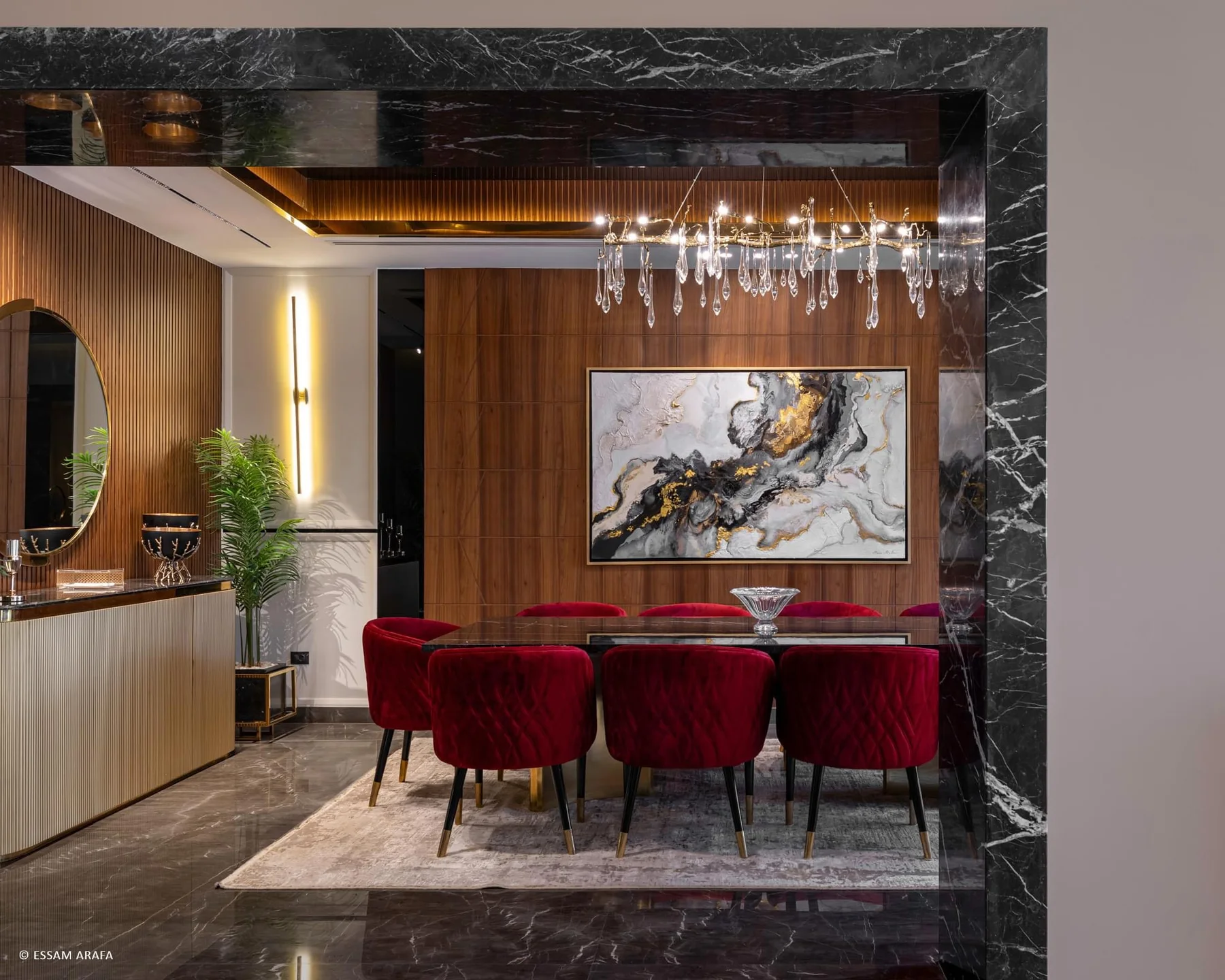 Dining room framed by timber, marble and a continuous built-in wall
